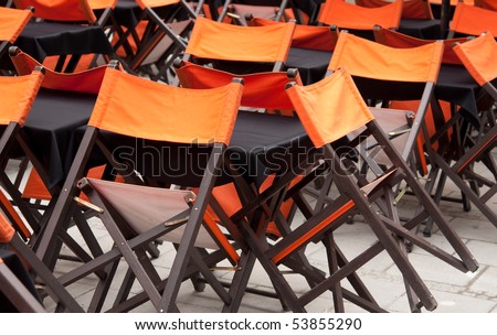 Tables and chairs in closed open-air cafe