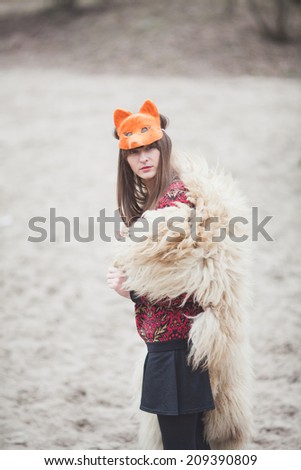 woman in mask of a fox, in the park