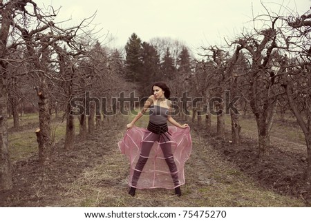 beautiful woman in a pink skirt fashion in the fairy forest