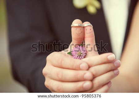 stock photo wedding rings on her fingers painted with the bride and groom 