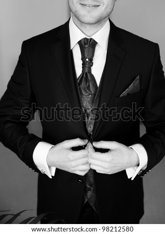 groom in a wedding jacket and tie, black and white