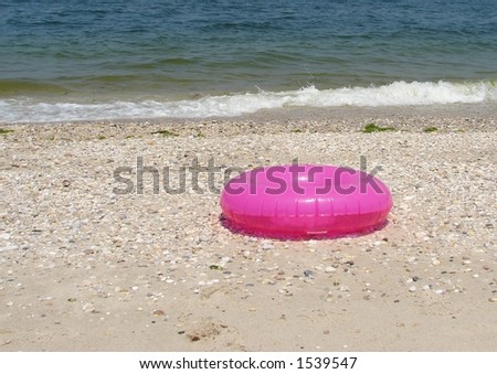 pink tube on the beach