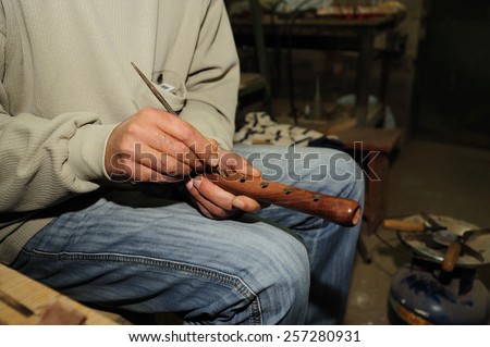 Central Asia, Caucasus mountains Armenia, handicraft realization of a particular flute called duduk.  The wood used is the apricot. Manual finishing holes for notes