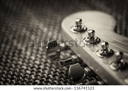 Electrical guitar head stock closeup. Sepia, vignette
