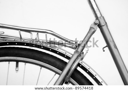 Old retro cruiser bike. Tire is visible. Black and white against white background