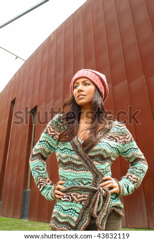A beautiful natural looking model poses in her winter outfit