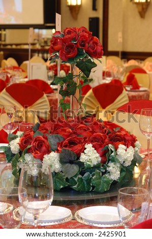 stock photo Wedding banquet table setting with a bouquet of red roses