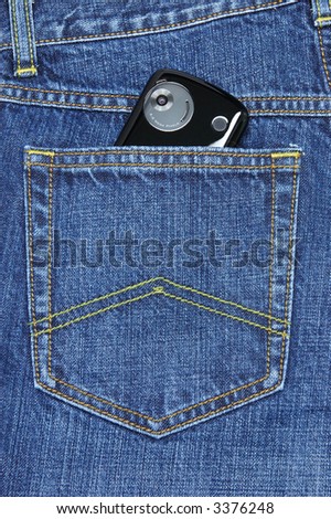 Digital camera lens of pda phone in blue jeans pocket