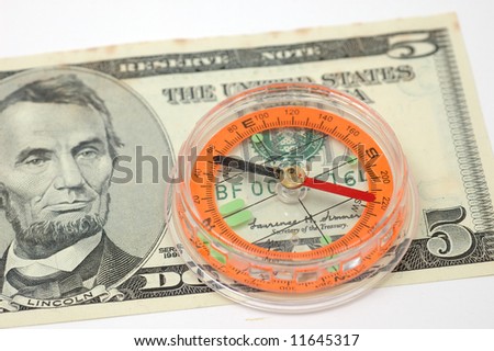 Close up of compass on US five dollar bill