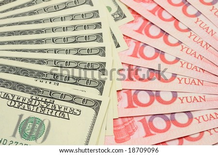Closeup of fanned US dollar and China yuan bills