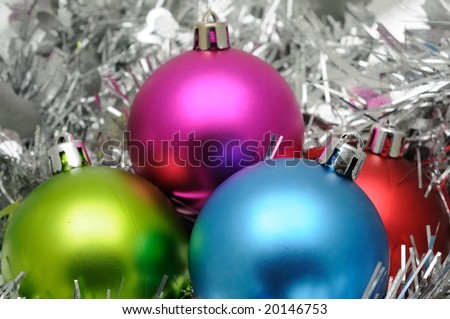 Colorful christmas balls in silver garland background