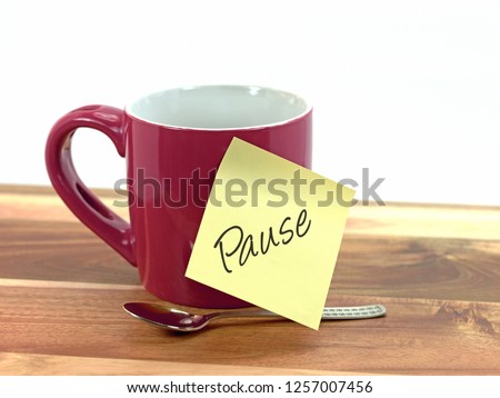 Coffee cup with sticky note saying break,\