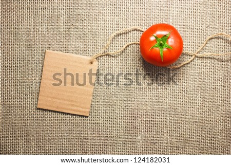 tomato vegetable and price tag on sacking background texture