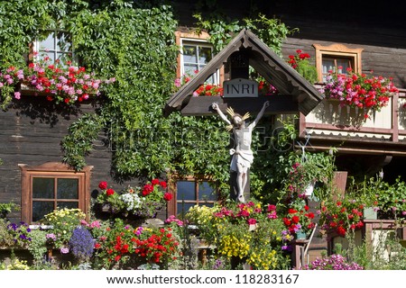 Decorated with flowers and wooden cross -  house in East Tyrol