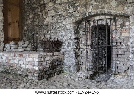 Old stones - stone wall and grated door in abandoned ruins