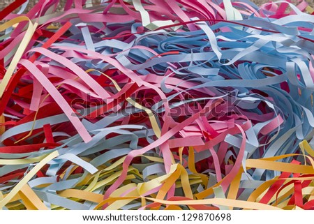 Lots of colorful scraps of paper shredded by a shredder