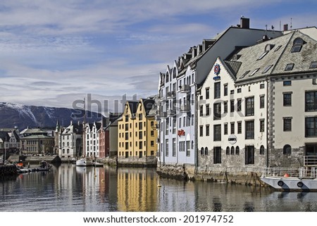 Colorful storage houses lining the banks in the charming city of Alesund in Norway