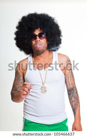 Hip hop urban black man retro afro hair wearing white shirt and golden jewelry isolated on white. Smoking cigarette. Looking confident. Cool guy. Studio shot.