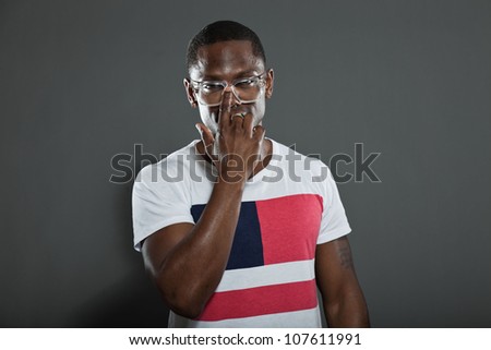 Cool urban stylish black american man. Fashion studio portrait isolated on grey background. Wearing retro glasses.