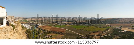 Panoramic photo overviewing the agrarian landscape of Sierra de Grazalema. Seen from pueblo blanco Arcos de la Frontera, Cadiz. Andalusia. Spain.