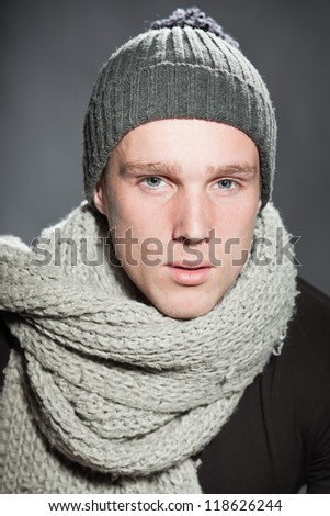Winter fashion studio portrait of urban young man wearing woolen hat.
