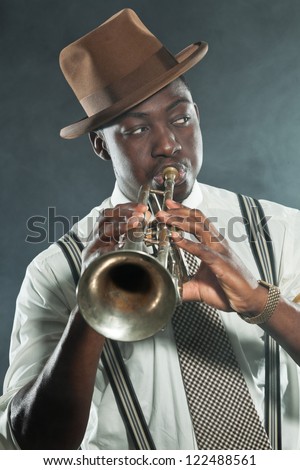 Black african american jazz trumpet player. Vintage. Studio shot.