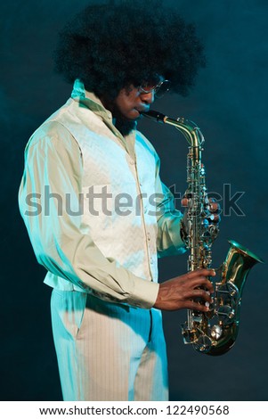 Black american jazz saxophone player. Vintage. Studio shot.