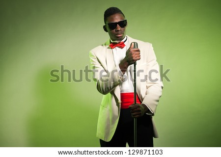 Singing black american man in suit wearing sunglasses. Vintage.
