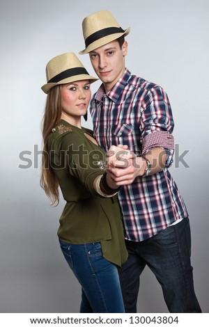 Dancing young couple in love. Man and woman. Studio shot.
