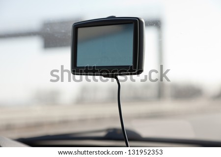 Car navigation system on front window in car.