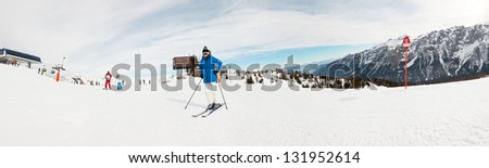 Panorama of winter sport snow mountain landscape with ski woman.