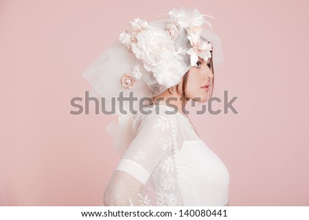 Vintage romantic bride with long hair in white wedding dress. Decorated with flowers.