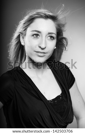 Fashion beauty portrait of pretty girl with long blonde hair. Black and white shot.