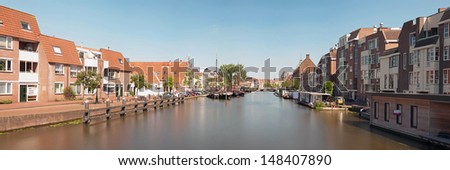 Panoramic photo of dutch city Leiden in summer. Canal and houses.