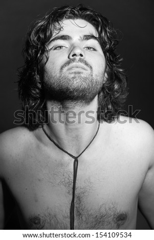 Black and white portrait of psychedelic rock style musician. Rockstar performer with arrogant looks.
