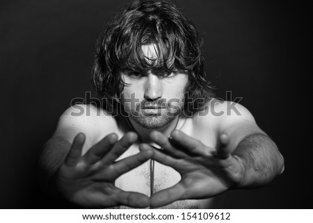 Black and white portrait of psychedelic rock style musician. Rockstar performer with arrogant looks.