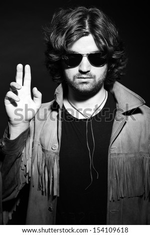 Black and white portrait of rock style musician. Wearing sunglasses.