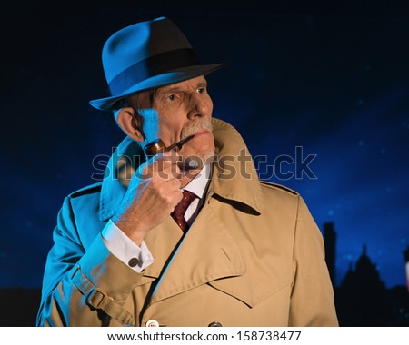 Retro detective man smoking pipe walking in city street at night. Wearing a hat and raincoat. Mysterious atmosphere.