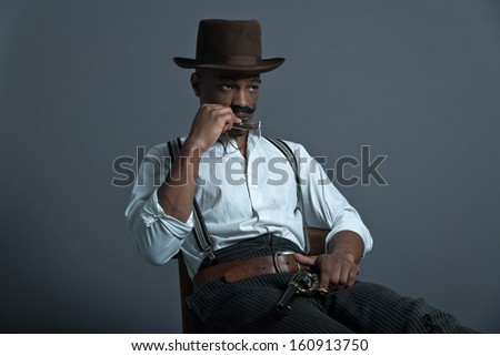 Harmonica playing retro afro america western cowboy man with mustache. Sitting in wooden chair. Wearing brown hat. Cool tough guy.