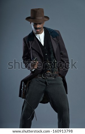 Shooting retro Afro america western cowboy man with mustache. Wearing brown hat. Cool tough guy.