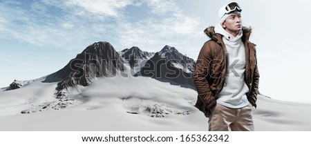 Asian Winter Sport Fashion Man In Snow Mountain Landscape. Wearing Brown Jacket And Brown Trousers.