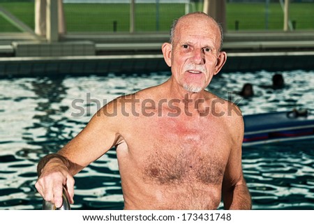 Senior man walking out of swimming pool.