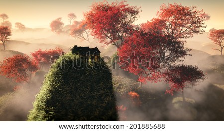 Aerial of fantasy grassy hill landscape with red autumn trees and lonely house on rock in the mist.