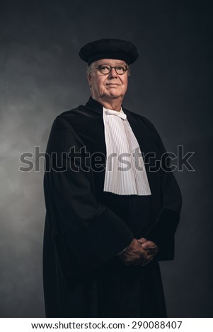 Waist Up Portrait of Serious Magistrate Wearing Traditional Historical Costume, Mature Man Standing in Studio with Grey Background
