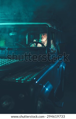 Brave Middle Age Man Driving Alone his 4x4 Vehicle Going Home in the Middle of Fuzzy Dark Night.