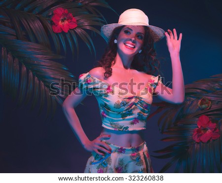 Tropical Pin-up Girl with Straw Hat. Evening Light in Front of Palm Leaves.