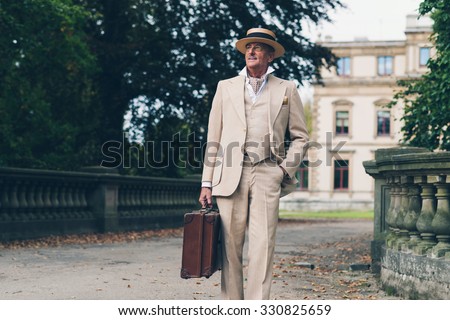Vintage commercial traveler leaving his estate walking towards camera.