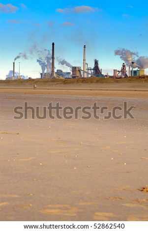 Beach with industrial skyline