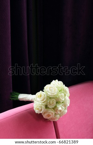 stock photo White wedding flowers on purple bench