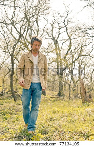 Young casual man walking in nature.